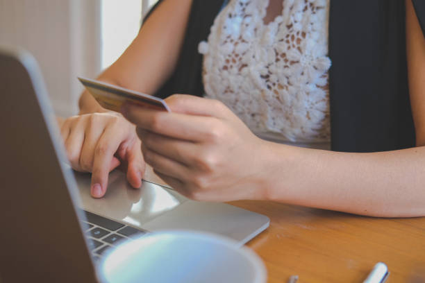 istock woman using computer & credit card for online shopping 1172344280