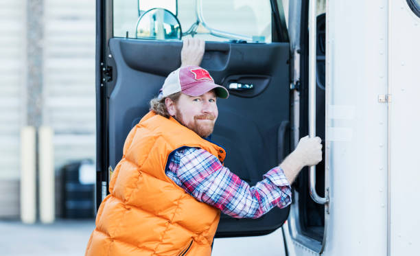 Trucker driver climbing into his semi-truck