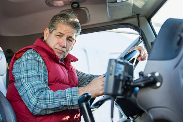 istock Senior Hispanic man driving semi-truck 1172345263