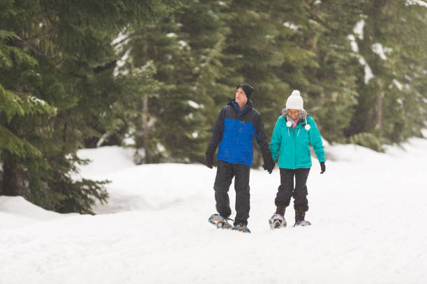 istock A senior couple snowshoeing in the forest 1172345991