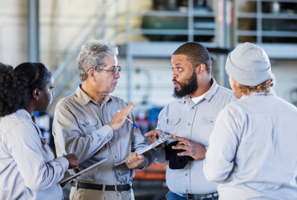 istock Workers in repair shop having a meeting 1172346996