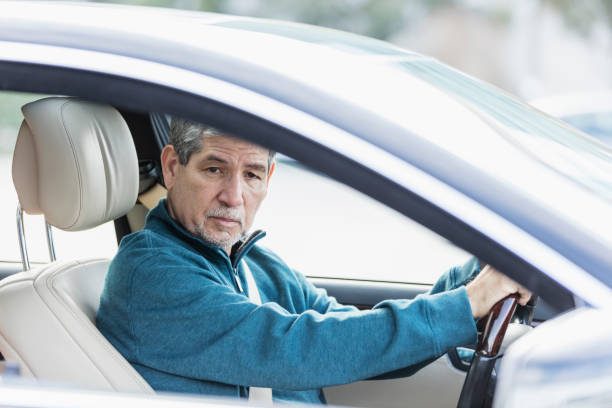 istock Senior Hispanic man driving a car 1172351194