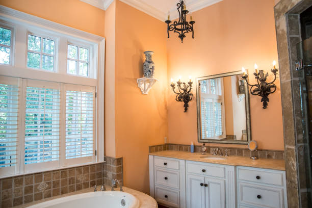 istock Large Spacious Master bathroom painted in a peach orange color 1172351287