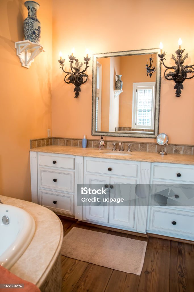 Large Spacious Master bathroom painted in a peach orange color Bathroom Stock Photo