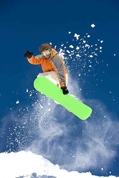 Snowboarder Against A Bright Blue Sky stock photo