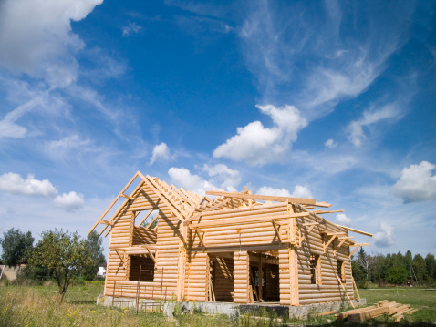 log cabin  under construction  in countryside.  http://www.istockphoto.com/file_thumbview_approve.php?size=1&id=6391564
