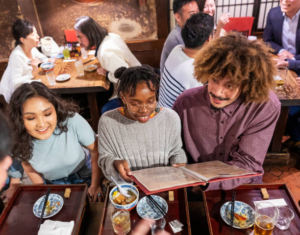 istock Young Friends Enjoying a Night Out at a Restaurant 1172360884
