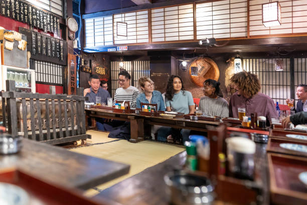 istock People Enjoying a Dinner and Drinks at a Restaurant in Tokyo 1172360894