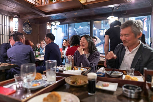 istock People Enjoying a Dinner and Drinks at a Restaurant in Tokyo 1172360895