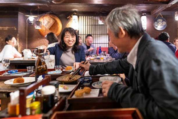 istock People Enjoying a Dinner and Drinks at a Restaurant in Tokyo 1172360903