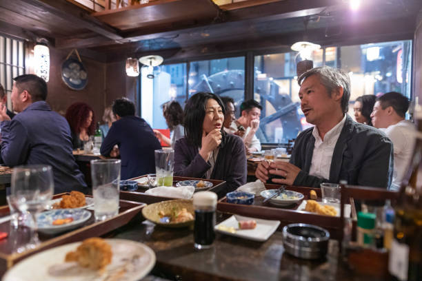 istock People Enjoying a Dinner and Drinks at a Restaurant in Tokyo 1172360904