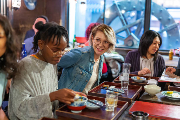 istock Young Friends Enjoying a Night Out at a Restaurant 1172360916