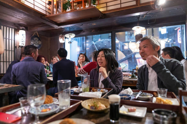 istock People Enjoying a Dinner and Drinks at a Restaurant in Tokyo 1172360927