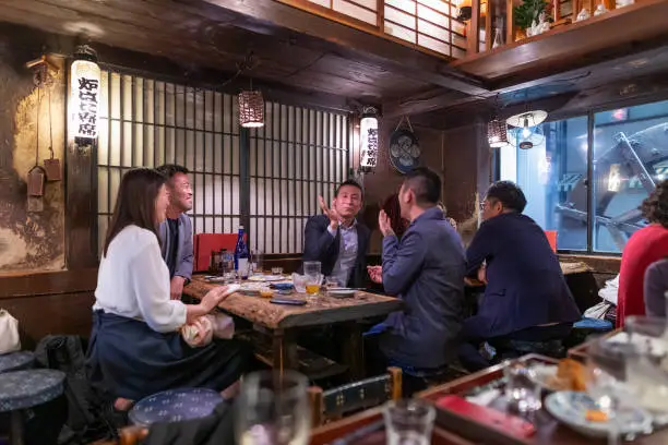 People Enjoying a Night Out at a Restaurant in Tokyo