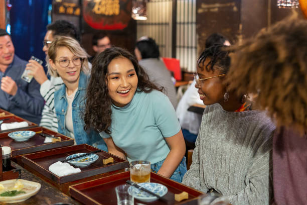 istock Young Friends Enjoying a Night Out at a Restaurant 1172360965