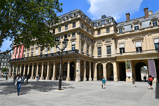 Paris, France-07 11 2019: People walking on the Place Colette, a square in Paris, which is bordered by the Palais-Royal and the Comédie-Française.The Comédie-Française or Théâtre-Français is considered the oldest still-active theatre in the world.