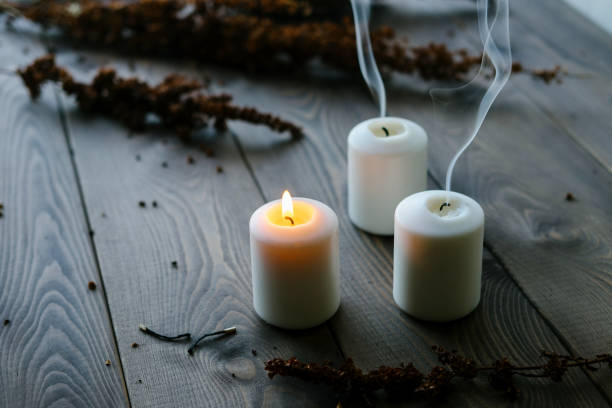 istock White Candles Burning On Wooden Tabletop 1172364624