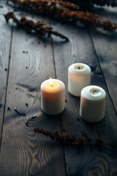 istock White Candles Burning On Wooden Tabletop 1172364699