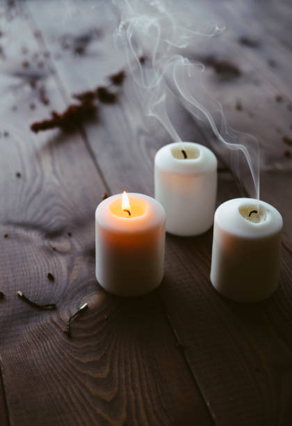 istock White Candles Burning On Wooden Tabletop 1172364781