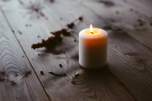 istock White Candle Burning On Wooden Tabletop 1172364913