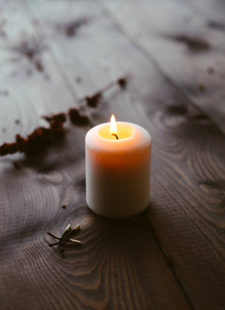 istock White Candles Burning On Wooden Tabletop 1172364927