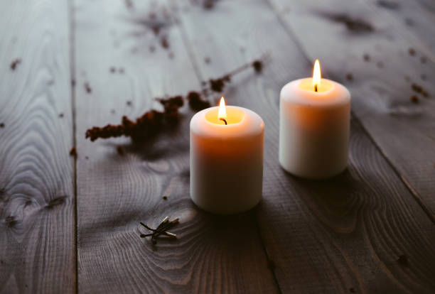 White Candles Burning On Wooden Tabletop