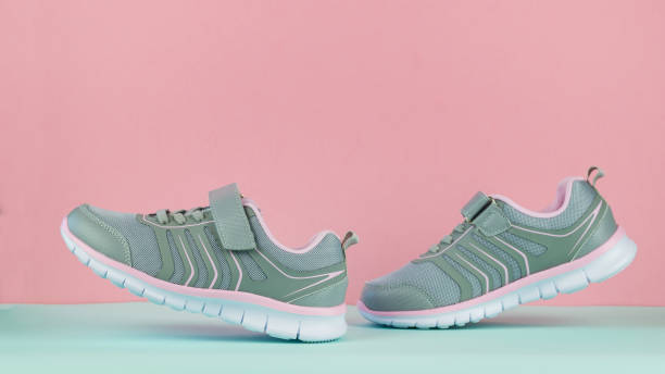 istock Walking sneakers on a blue background against a red wall. 1172367668