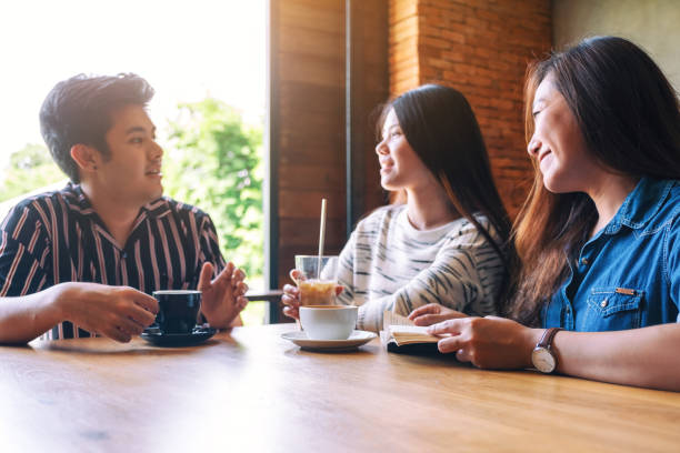 istock people enjoyed talking and drinking coffee together in cafe 1172369195