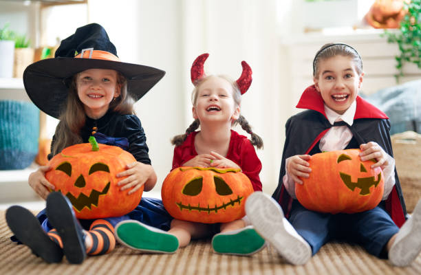 istock kids with carving pumpkin 1172373302
