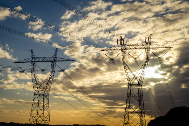 istock Two large electricity pylons at sunset 1172379145