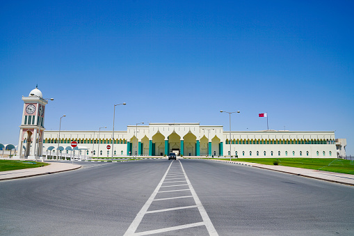 Qatar Parliament Building, and clocktower at end of entrance road leading to Arabic styled façade.