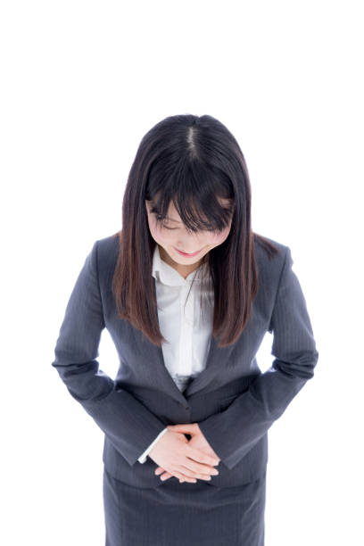 istock Young business woman bowing isolated on white background 1172393672