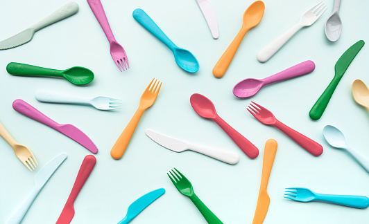 Top view of colorful spoon and fork element on color table.flat lay design