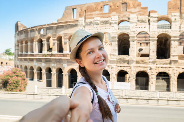 istock Happy Woman Pulling Her Boyfriend While Walking To Colosseum 1172394539