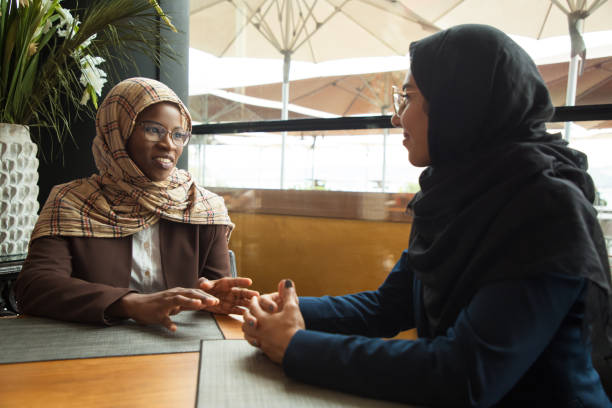 istock Muslim female colleagues chatting during lunch break 1172401599