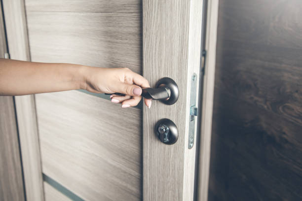 istock woman opening door 1172403022