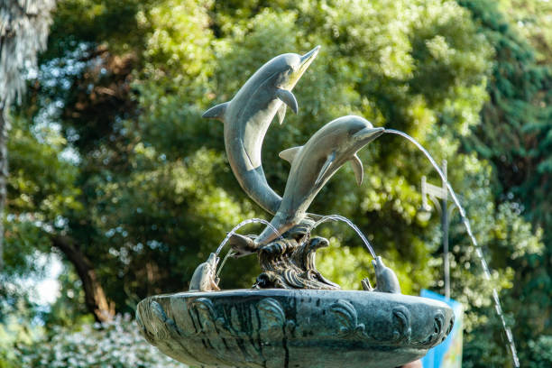 istock dolphin statue with water in nature 1172403053