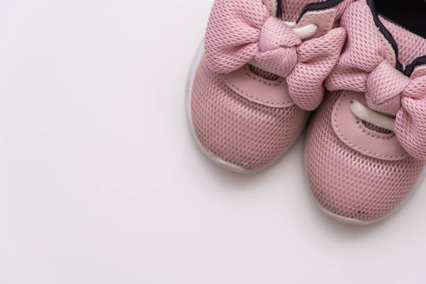 istock On a white background, pink baby sneakers, copy space 1172403180