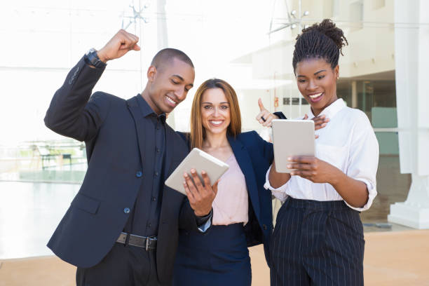 istock Cheerful business colleagues with tablets 1172404759