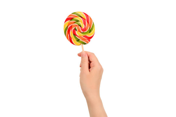 istock Lollipop in female hand isolated on white  background. Space for text or design. 1172407537