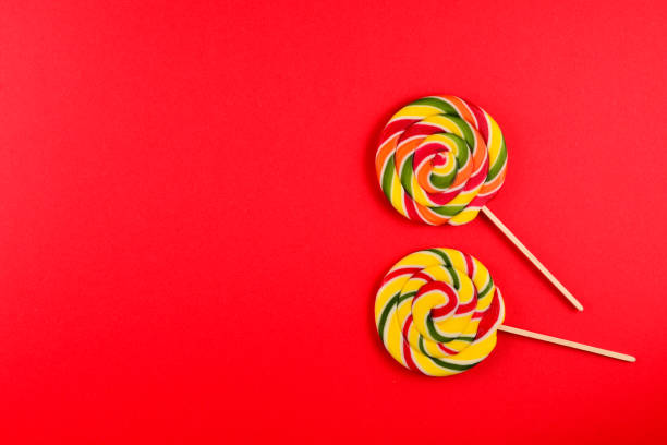 istock Colorful candy on a red  background. Lollipop. Top view. Copy space. 1172407557
