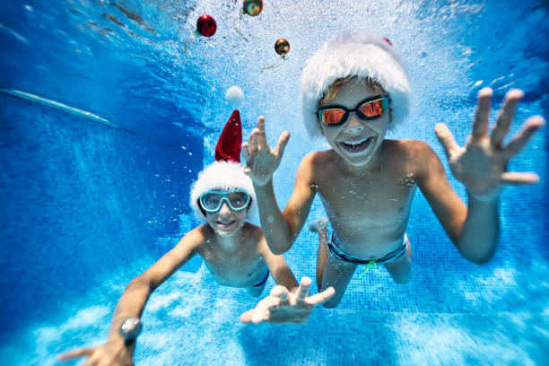 istock Kids playing with baubles in pool on summer Christmas 1172410875