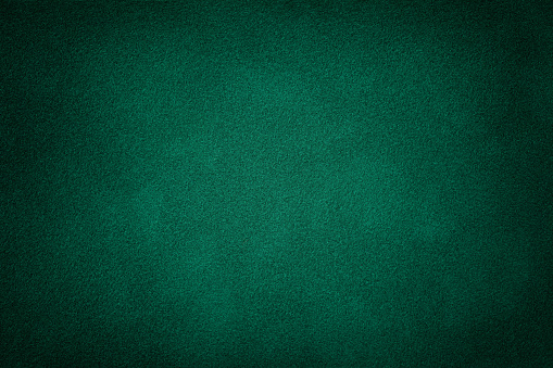 Primer plano de ante mate verde oscuro. Textura de terciopelo. photo