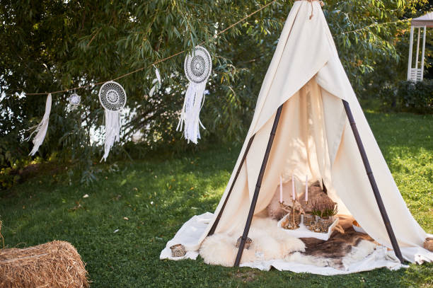 istock Boho style, wedding decoration.Ease and simplicity.A bamboo hut covered with a linen cloth. Decorative place. Outdoor recreation. Glamping 1172416375