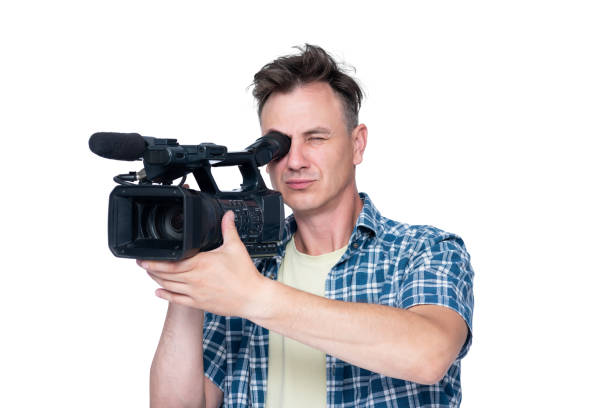 istock Man shoots a video with a professional camcorder, isolated on white background 1172418374
