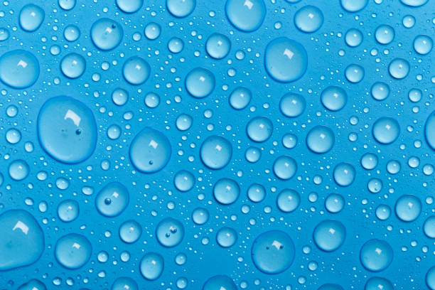 istock Rain droplets on blue glass background, Water drops on blue glass. 1172418463