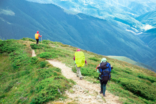istock three unrecognizable girls on the mountain trail walking down to the walley 1172418491