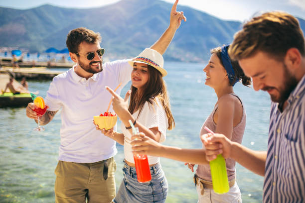 istock Friends at the beach drinking cocktails having fun on summer vacation 1172419983
