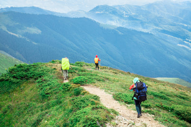 istock three unrecognizable girls on the mountain trail walking down to the walley 1172420420