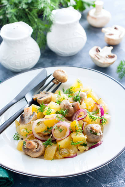istock Potato salad with marinated champignons on a white plate, selective focus 1172422538